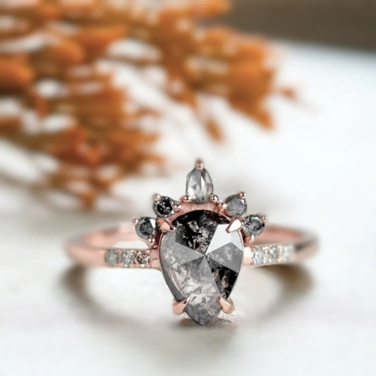 Rose Pear Salt And Pepper Diamond Ring With Grey Diamonds featuring a rose pear cut salt and pepper diamond center stone, grey diamond side stones, straight shank engagement ring design, and a refined vintage-inspired style.