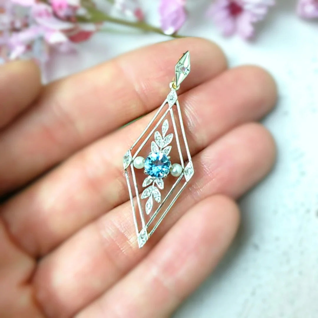 Aquamarine Necklace Round Brilliant Solitaire Pendant: Elegant pendant featuring a round brilliant aquamarine gemstone in a minimal solitaire pendant design with a soft sky blue tone, set on a delicate cable chain with a secure clasp closure
