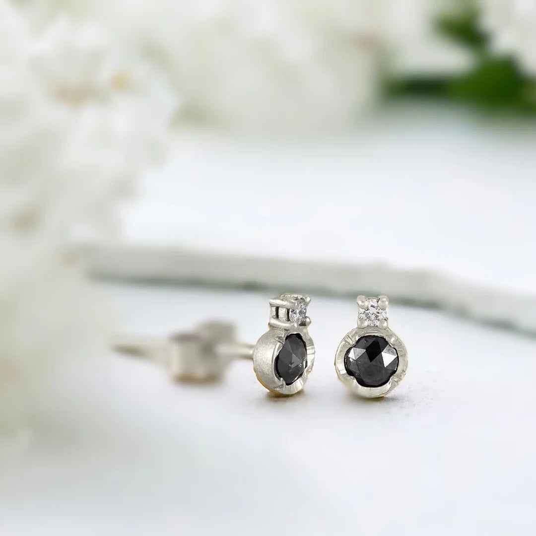 Black Diamond Solitaire Stud Earrings with Rose-Cut Diamonds featuring round rose-cut salt-and-pepper diamonds in a solitaire-inspired stud earring design with a push-back closure.