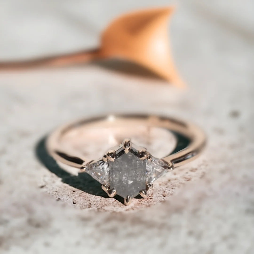 Brooklyn Wedding Rings Custom Salt and Pepper Diamond Ring featuring a hexagon-cut salt-and-pepper diamond center stone with trillion-cut side diamonds in a geometric side stone ring design and straight shank setting.