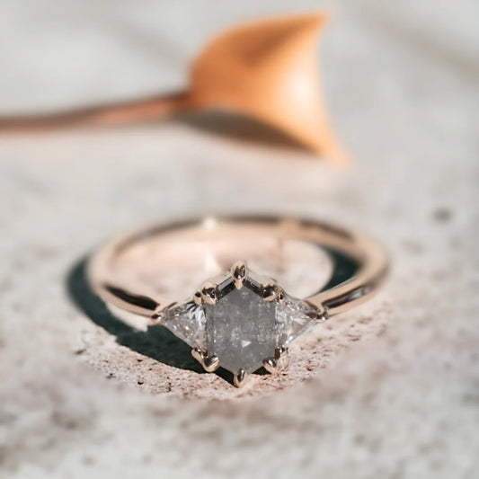 Brooklyn Wedding Rings Custom Salt and Pepper Diamond Ring featuring a hexagon-cut salt-and-pepper diamond center stone with trillion-cut side diamonds in a geometric side stone ring design and straight shank setting.