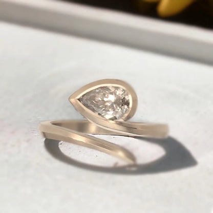 Brown Diamond Ring Cognac Pear Diamond Bezel Set Ring Gold Band featuring a 1.35 CT pear-shaped natural brown diamond in warm cognac tones, secured in a smooth bezel setting with a modern gold band and elegant bypass shank design.