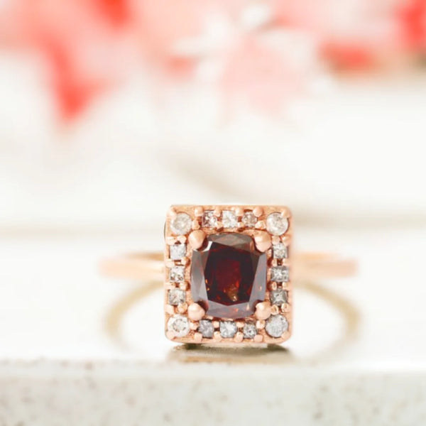 Champagne Diamond Cushion Halo Ring in Red Gold Engagement Ring featuring a cushion-cut champagne salt-and-pepper diamond with a halo setting, red gold band and round and princess accent stones