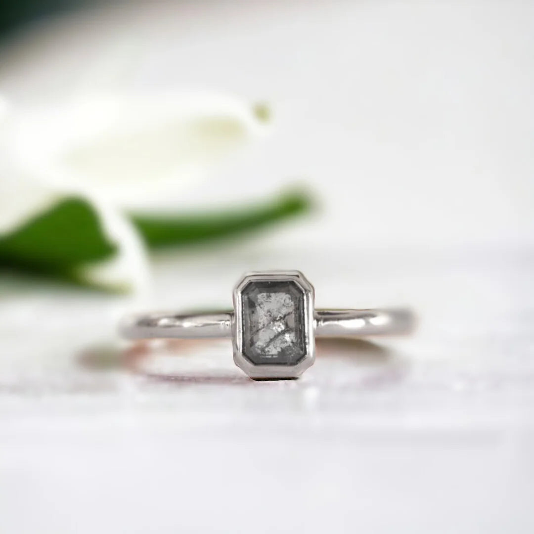 Emerald Cut Salt and Pepper Diamond Ring Pavé Fine Jewellery Ring featuring an emerald cut salt and pepper diamond set in a minimalist pavé fine jewellery ring design with a slim straight band and clean modern silhouette highlighting natural inclusions and refined elegance.