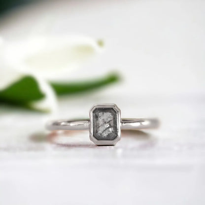Emerald Cut Salt and Pepper Diamond Ring Pavé Fine Jewellery Ring featuring an emerald cut salt and pepper diamond set in a minimalist pavé fine jewellery ring design with a slim straight band and clean modern silhouette highlighting natural inclusions and refined elegance.