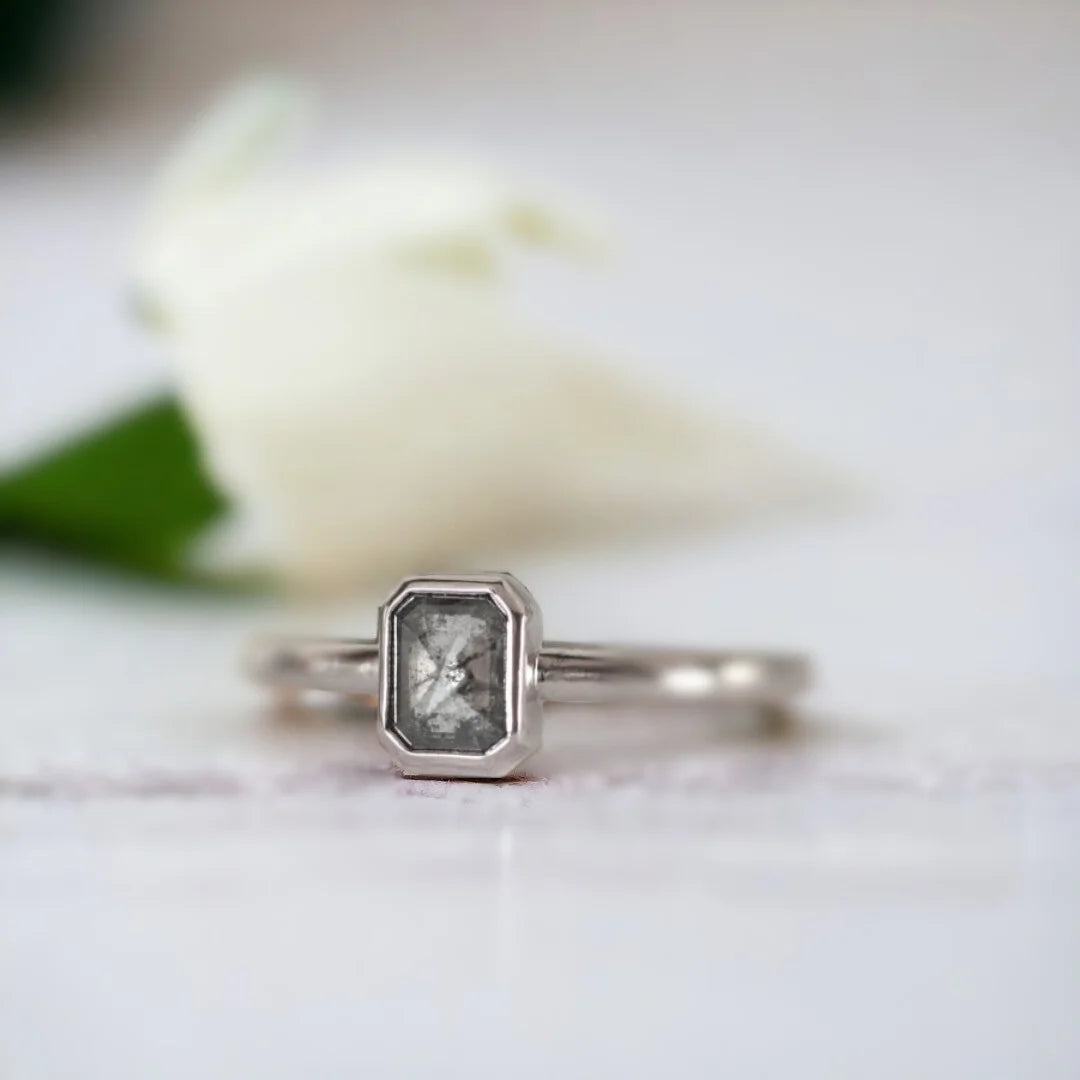 Emerald Cut Salt and Pepper Diamond Ring Pavé Fine Jewellery Ring featuring an emerald cut salt and pepper diamond set in a minimalist pavé fine jewellery ring design with a slim straight band and clean modern silhouette highlighting natural inclusions and refined elegance.