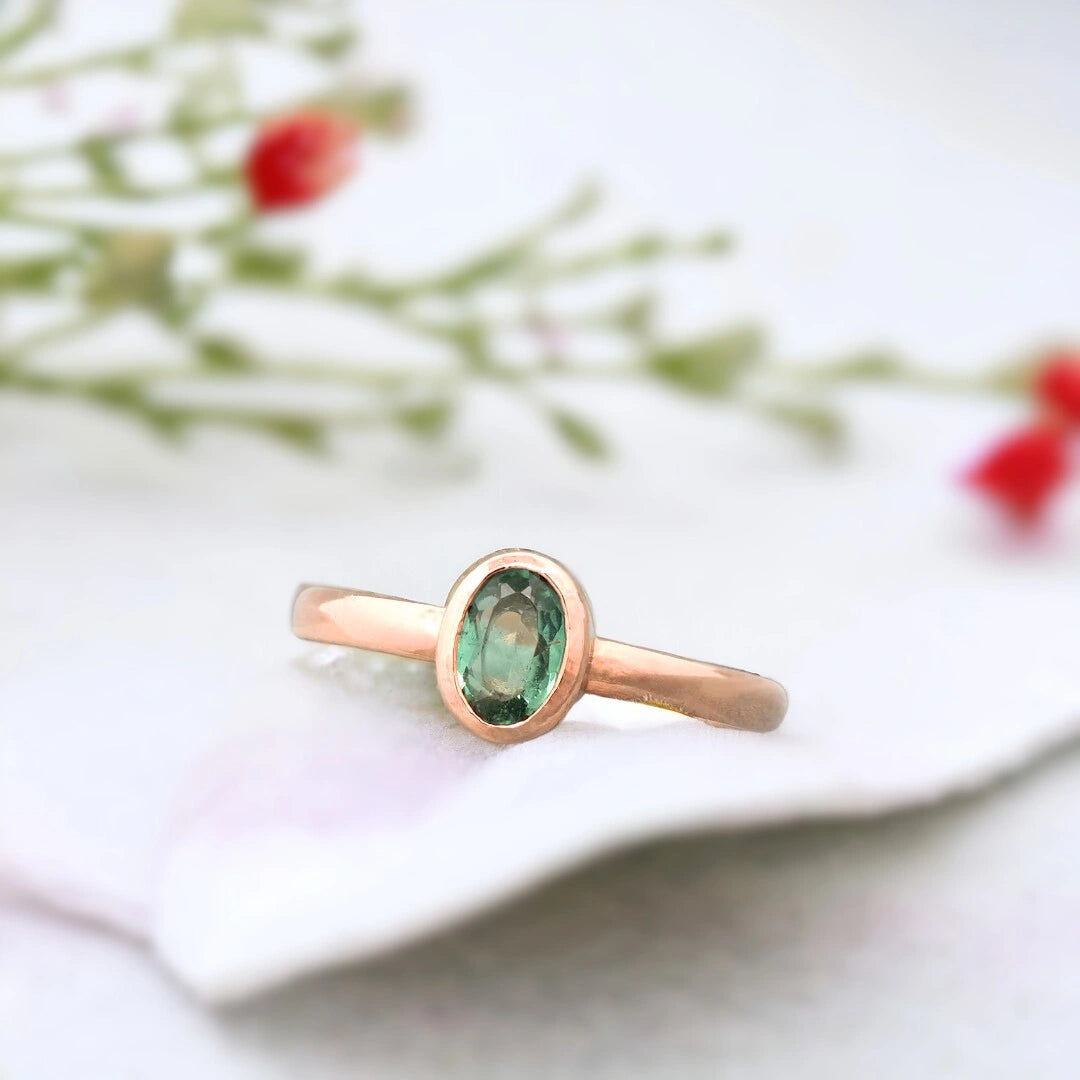 Green Sapphire Ring Bezel Set Minimalist Oval Vintage Design featuring a natural oval green sapphire in a bezel setting with a smooth minimalist band and subtle handcrafted texture in a vintage-inspired fine jewellery style