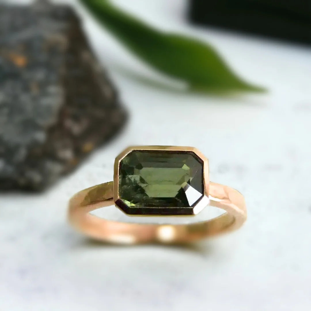 Green Sapphire Engagement Ring Floating Bezel Vintage Style featuring a natural step-cut green sapphire in a floating bezel setting with a straight shank band and vintage inspired engagement ring design.