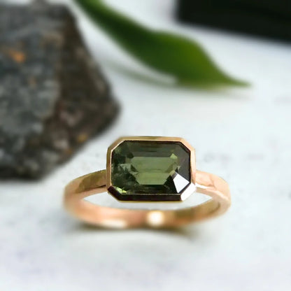 Green Sapphire Engagement Ring Floating Bezel Vintage Style featuring a natural step-cut green sapphire in a floating bezel setting with a straight shank band and vintage inspired engagement ring design.