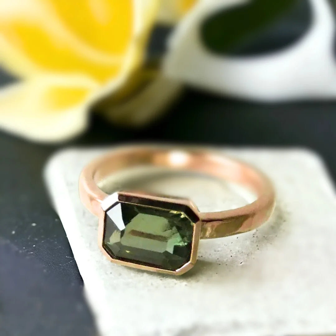 Green Sapphire Engagement Ring Floating Bezel Vintage Style featuring a natural step-cut green sapphire in a floating bezel setting with a straight shank band and a vintage-inspired engagement ring design.