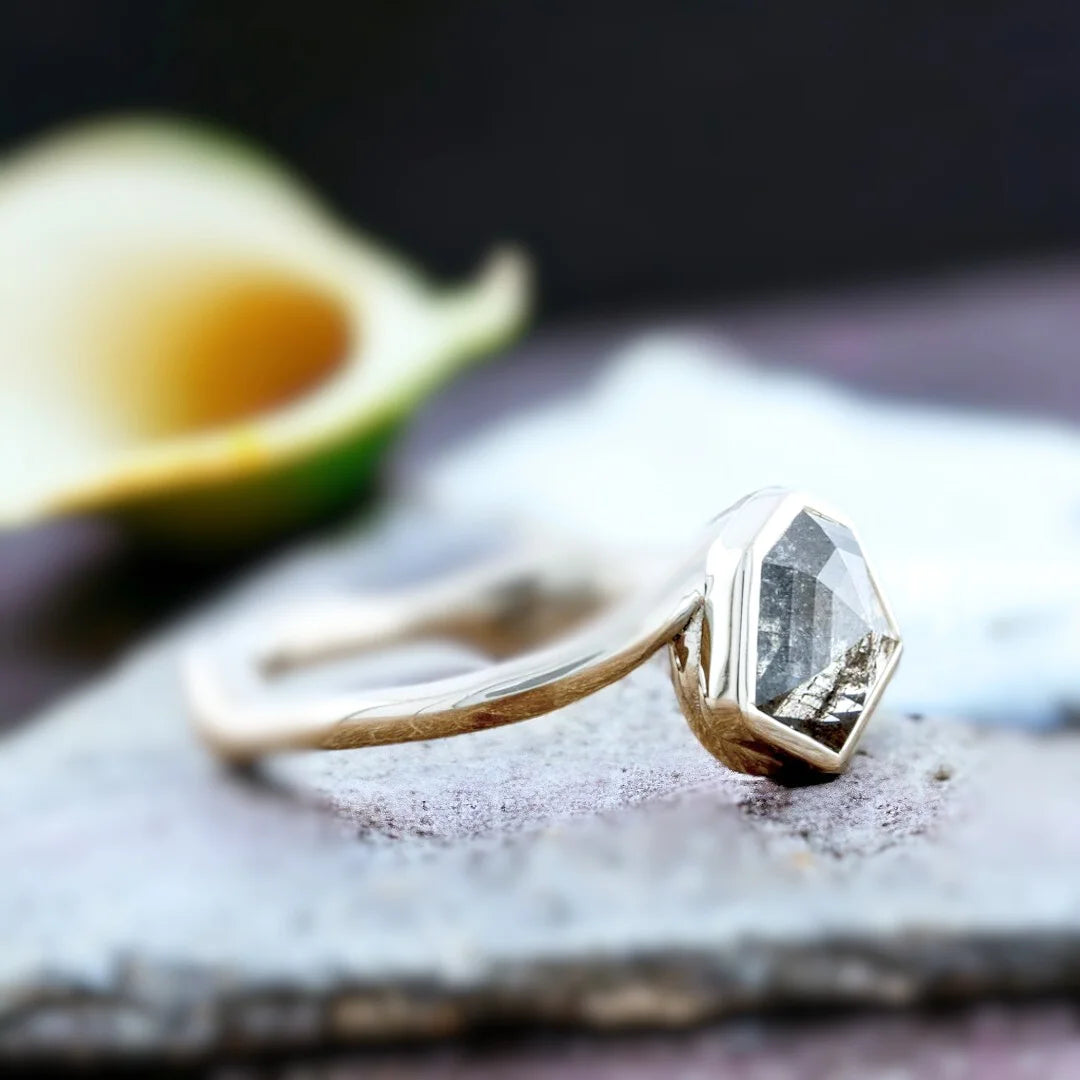 Grey Hexagon Diamond Bezel Engagement Ring, Nature-Inspired, featuring a natural salt-and-pepper shield-cut diamond in a geometric bezel setting with a bypass shank band and modern minimalist design.