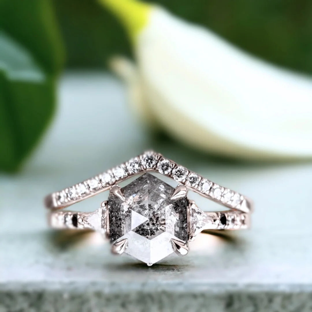 Hexagon Salt and Pepper Diamond Ring with Geometric Diamond Design featuring a hexagon-cut salt-and-pepper diamond center stone, round side diamonds, geometric setting, flair shank band, and modern engagement ring style.