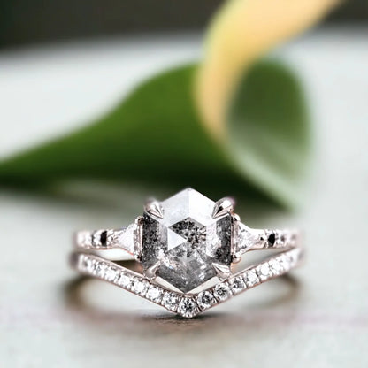Hexagon Salt and Pepper Diamond Ring with Geometric Diamond Design featuring a hexagon-cut salt-and-pepper diamond center stone, round side diamonds, geometric setting, flair shank band, and modern engagement ring style.