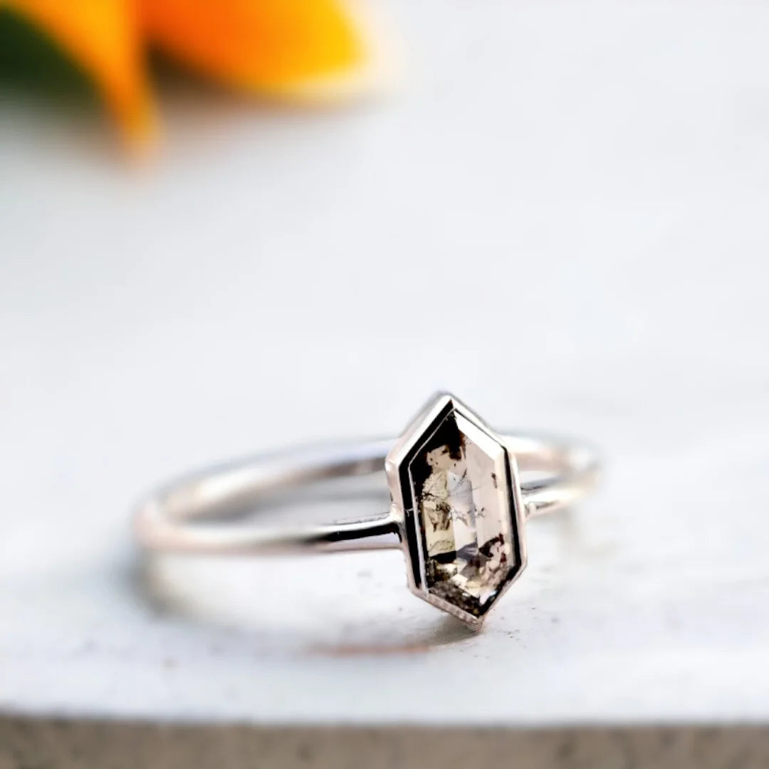 Salt And Pepper Rose Oval Diamond Ring Vintage Solitaire Design featuring a 1.22 CT hexagon cut salt and pepper diamond in a solitaire setting with a straight shank band and minimalist geometric ring design.