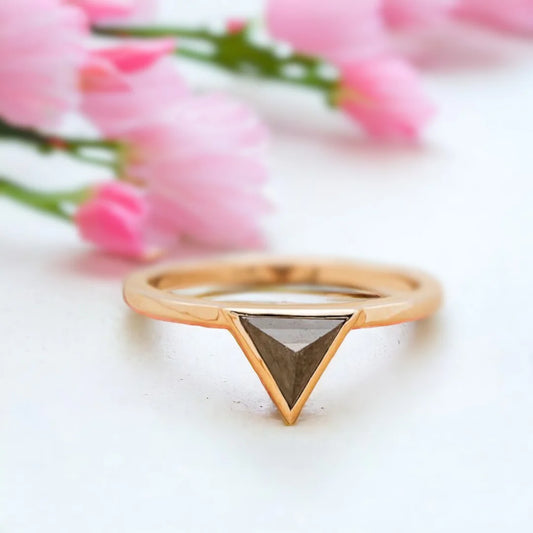 Jenny Triangle Diamond Engagement Ring Modern Geometric 1.25 Ct featuring a triangle-cut salt-and-pepper diamond center stone with black and white inclusions, accented by round side diamonds on a sleek, minimalist band with a clean, contemporary geometric setting