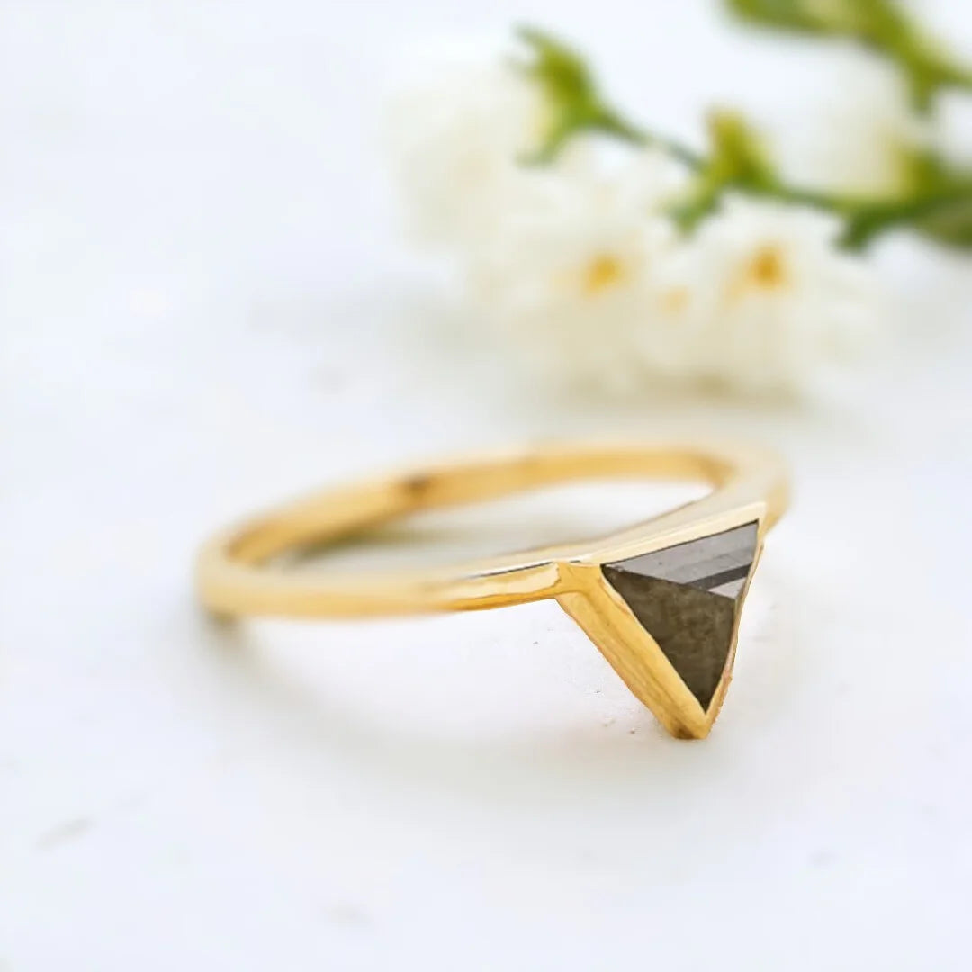 Jenny Triangle Diamond Engagement Ring Modern Geometric 1.25 Ct featuring a triangle-cut salt-and-pepper diamond center stone with black and white inclusions, accented by round side diamonds on a sleek, minimalist band with a clean, contemporary geometric setting