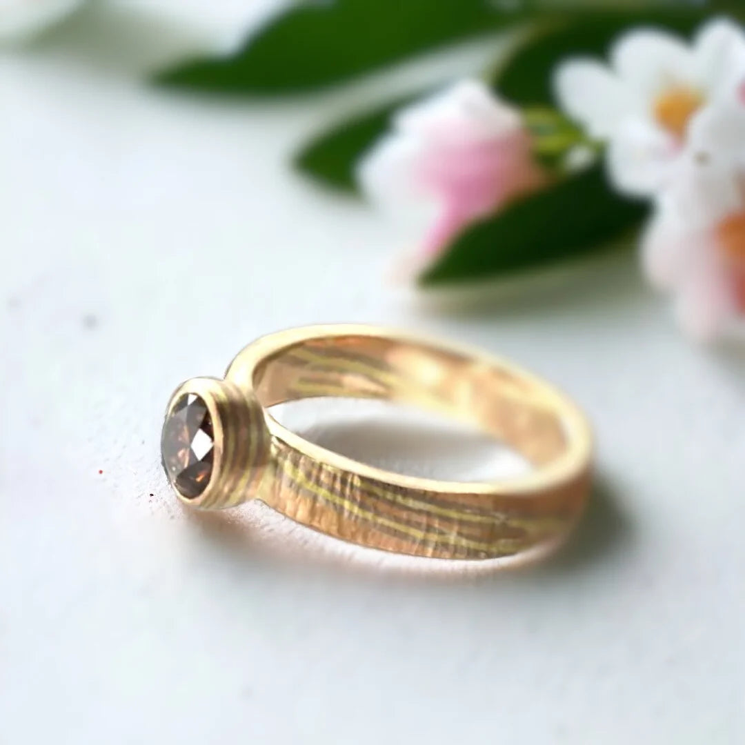 Natural Brown Diamond Ring with Round-Cut Diamond Design featuring a round-cut natural brown diamond in a handcrafted straight shank ring with organic detailing and a minimalist contemporary jewelry style.
