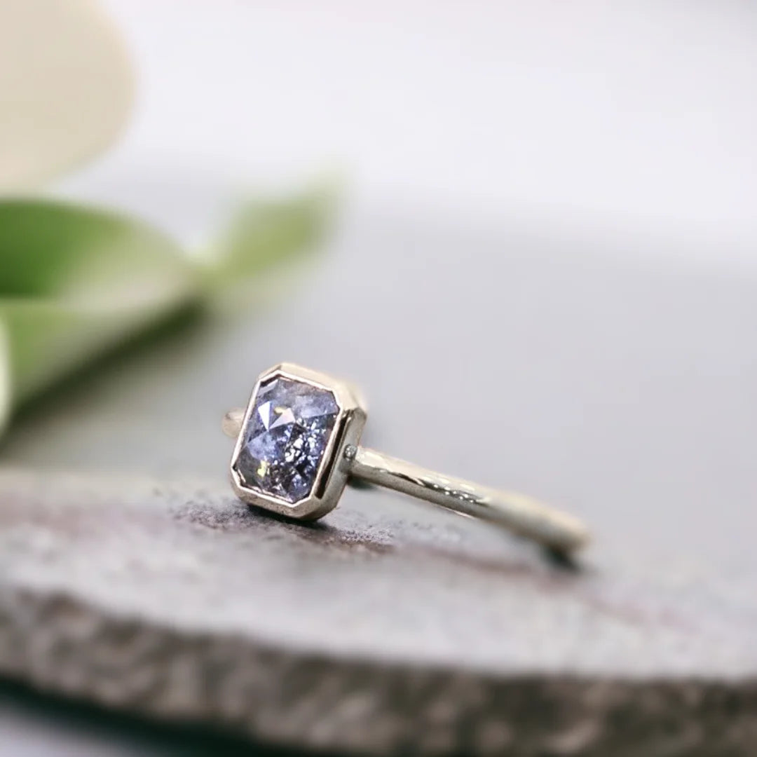 Natural Salt And Pepper Diamond Ring With Emerald Cut Design featuring a 0.84 CT emerald cut salt and pepper diamond in a modern minimalist ring style with a straight shank band and clean geometric silhouette.