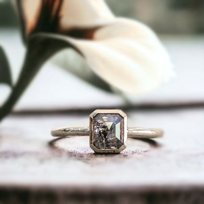 Natural Salt And Pepper Diamond Ring With Emerald Cut Design featuring a 0.84 CT emerald cut salt and pepper diamond in a modern minimalist ring style with a straight shank band and clean geometric silhouette.