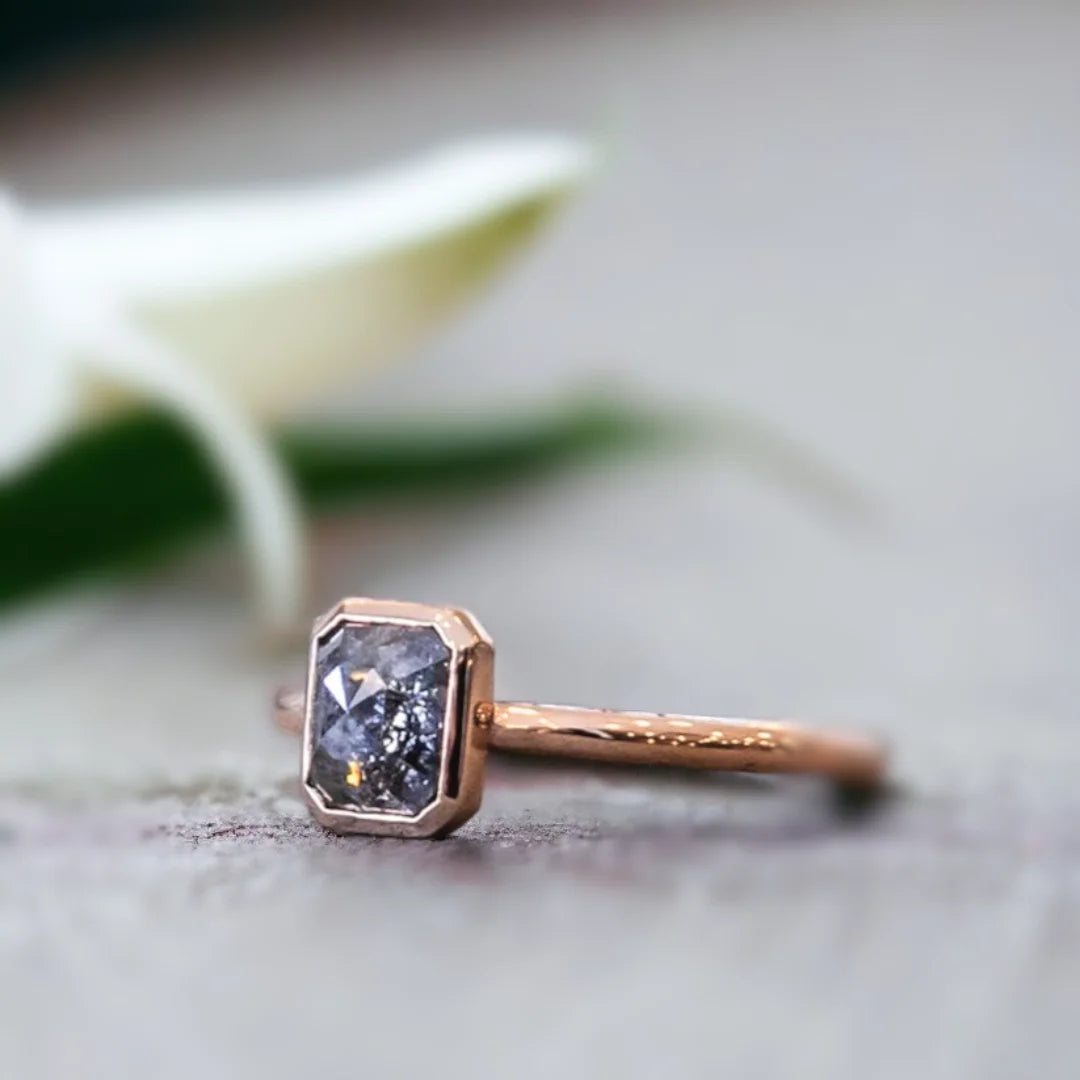 Natural Salt And Pepper Diamond Ring With Emerald Cut Design featuring a 0.84 CT emerald cut salt and pepper diamond in a modern minimalist ring style with a straight shank band and clean geometric silhouette.