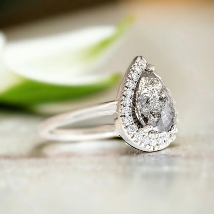Natural Salt and Pepper Diamond Ring with Pear-Cut Pavé Accents featuring a pear-cut natural salt and pepper diamond center stone with delicate pavé round diamond accents on a straight shank diamond engagement ring with an elegant handcrafted design.
