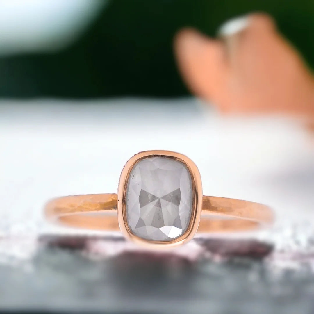 Natural Salt and Pepper Diamond Ring with Rose Cushion Cut Design featuring a cushion-cut salt-and-pepper diamond set in a straight band ring with a minimal handcrafted fine jewellery style and a soft, elegant silhouette.