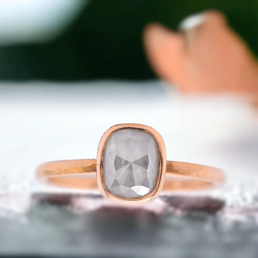 Natural Salt and Pepper Diamond Ring with Rose Cushion Cut Design featuring a cushion-cut salt-and-pepper diamond set in a straight band ring with a minimal handcrafted fine jewellery style and a soft, elegant silhouette.