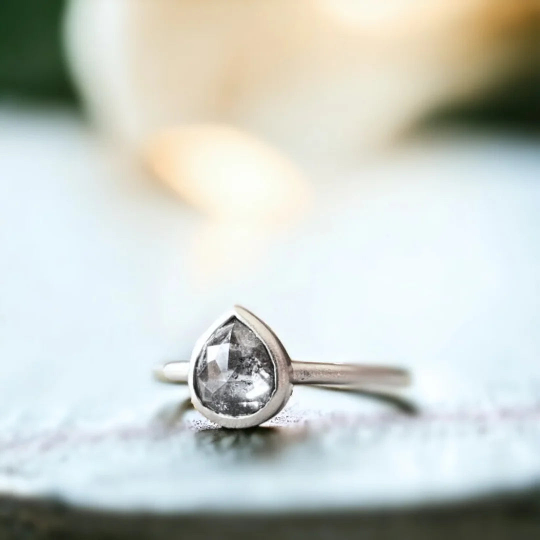 Natural Salt and Pepper Diamond Ring with Rose Pear Cut Design featuring a 0.72 CT rose pear-cut salt-and-pepper diamond in a minimalist engagement ring style with a straight shank band and clean, refined silhouette.