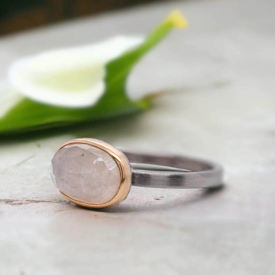 Natural Sapphire Ring With Elongated Rose Oval Sapphire featuring a natural elongated rose oval cut sapphire center stone on a handcrafted straight shank ring with an organic textured artisan design.