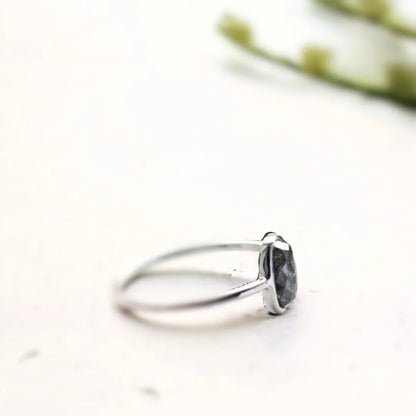 Oval Salt And Pepper Diamond Bezel Ring In White Gold featuring a 1.17 CT rose oval cut salt and pepper diamond in a white gold bezel setting with a minimalist engagement ring design and straight shank band.