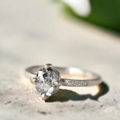 Oval Salt and Pepper Diamond Ring With Artisan Crafted Elegance featuring a rose oval cut salt and pepper diamond center stone with round side diamonds, straight shank band design, and artisan handcrafted ring style with organic layered detailing.