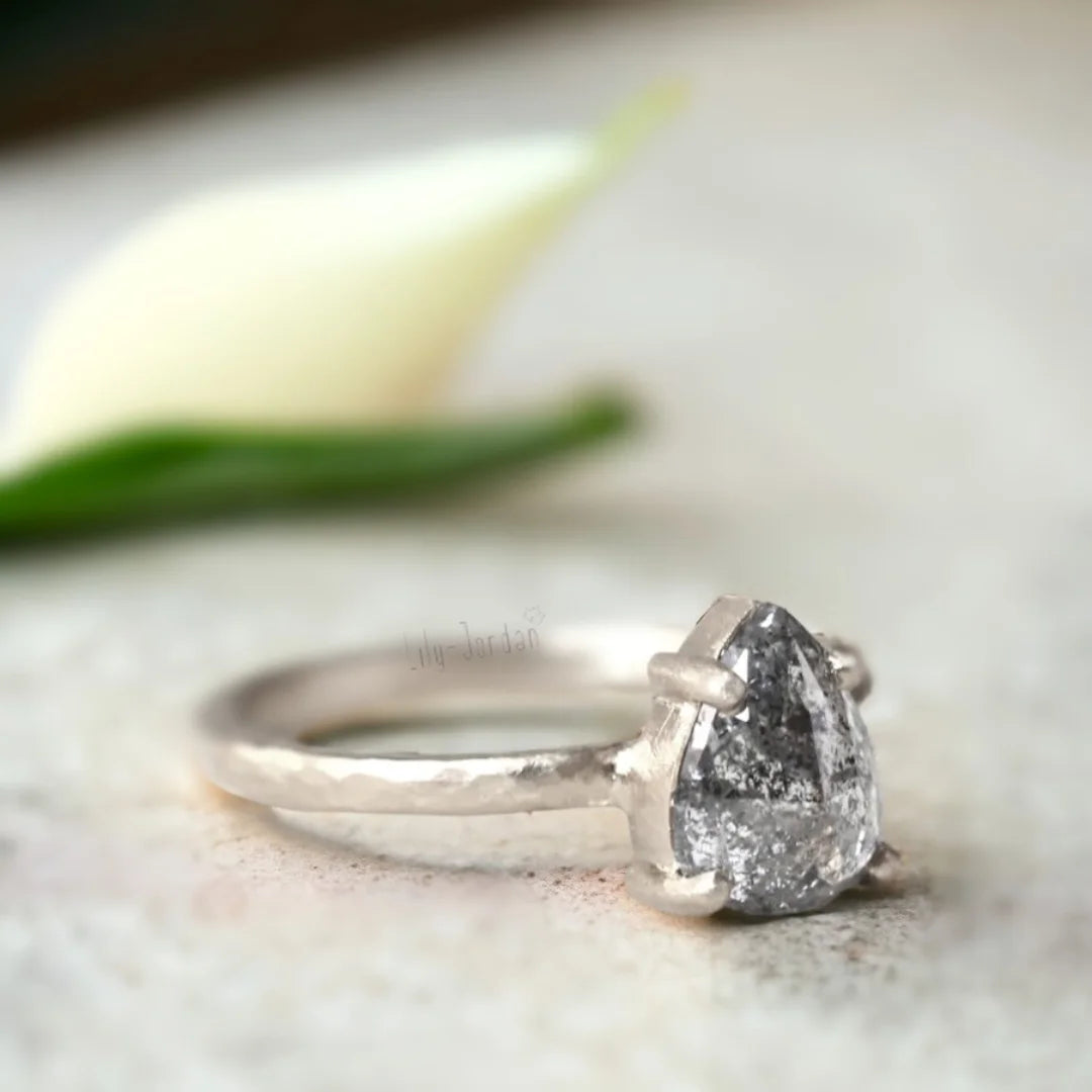 Pear-Cut Salt-and-Pepper Diamond Ring with Hammered Band Design featuring a 1.70 CT rose pear-cut salt-and-pepper diamond, straight shank band, and organic textured handcrafted ring design with unique natural diamond character.