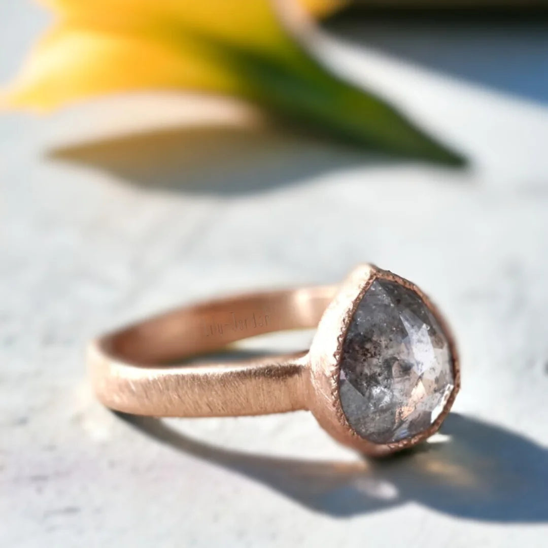 Pear Salt and Pepper Diamond Ring With One-of-a-Kind Sparkle featuring a rose pear-cut salt-and-pepper diamond in a statement ring design with an organic handcrafted finish and straight shank band.