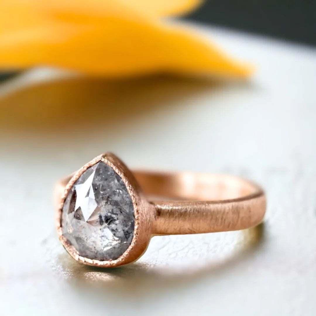 Pear Salt and Pepper Diamond Ring With One-of-a-Kind Sparkle featuring a rose pear-cut salt-and-pepper diamond in a statement ring design with an organic handcrafted finish and straight shank band.