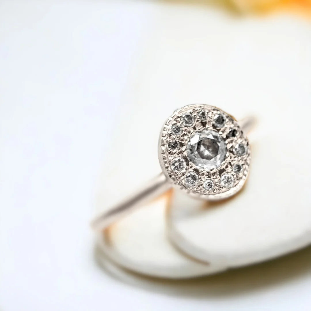 Pebble Gemstone Ring Unique Precious Jewellery Design With Diamonds featuring a round salt-and-pepper diamond accented by grey round side diamonds in a handcrafted pebble-inspired ring design.