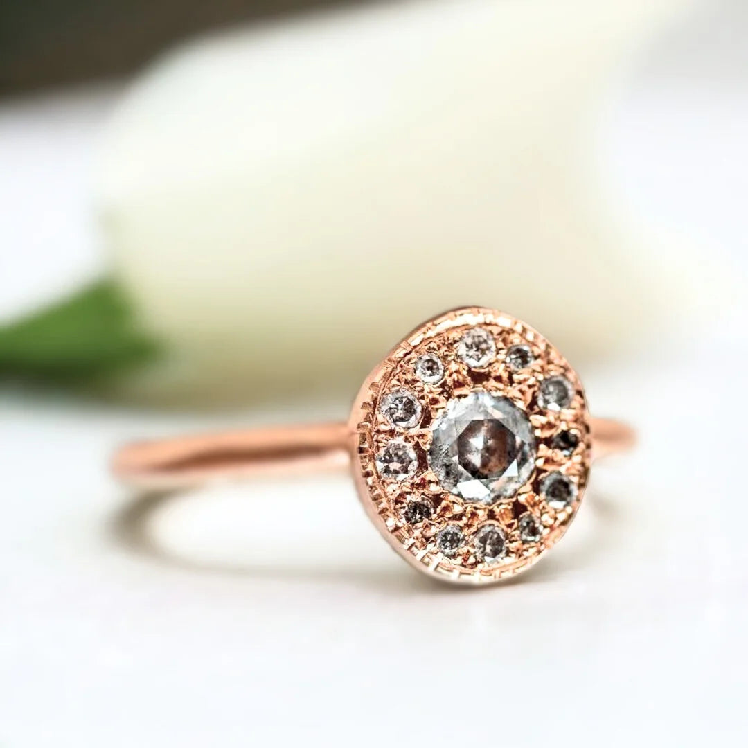 Pebble Gemstone Ring Unique Precious Jewellery Design With Diamonds featuring a round salt-and-pepper diamond accented by grey round side diamonds in a handcrafted pebble-inspired ring design.