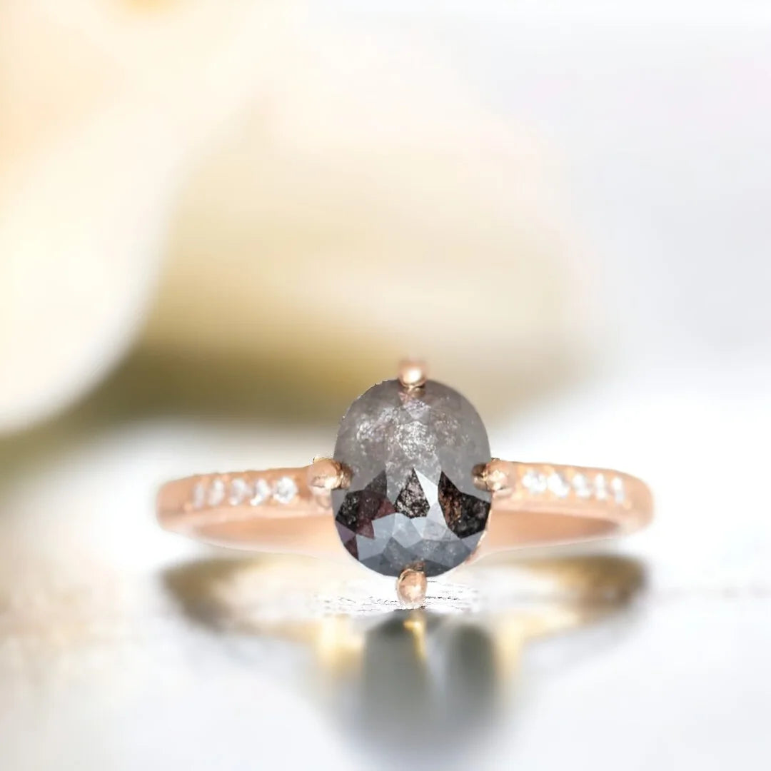 Rose Cushion Salt And Pepper Diamond Ring 1.70 CT featuring a rose cushion cut salt and pepper diamond with round side diamonds, a straight shank band, hand hewn ripple texture detailing, and an artisan crafted engagement ring design.