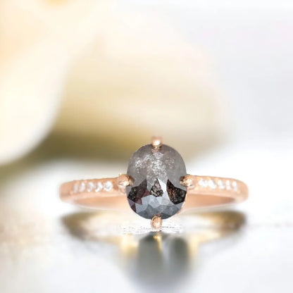 Rose Cushion Salt And Pepper Diamond Ring 1.70 CT featuring a rose cushion cut salt and pepper diamond with round side diamonds, a straight shank band, hand hewn ripple texture detailing, and an artisan crafted engagement ring design.