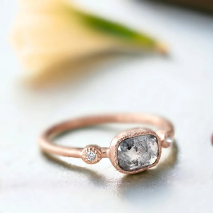 Rose Cushion Salt and Pepper Diamond Ring with Side Diamonds featuring a rose cushion-cut salt-and-pepper diamond center stone, round side diamonds, straight shank band, and handcrafted engagement ring design.