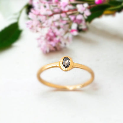 Rose Gold Salt and Pepper Diamond Ring Bezel Design in Rose Gold featuring an oval salt-and-pepper diamond in a bezel setting with a rose gold split shank band and a minimalist handcrafted design.