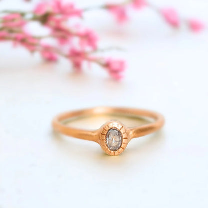 Rose Gold Salt and Pepper Diamond Ring Bezel Design in Rose Gold featuring an oval salt-and-pepper diamond in a bezel setting with a rose gold split shank band and a minimalist handcrafted design.