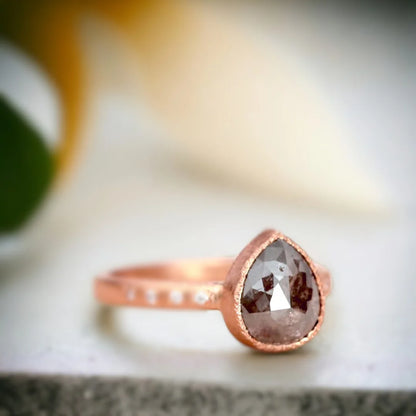 Rose Pear Salt and Pepper Diamond Ring with 2.70 CT Stone featuring a rose pear-cut salt-and-pepper diamond center stone, round side diamonds, straight shank band, and handcrafted artisan ring design with a textured organic finish.