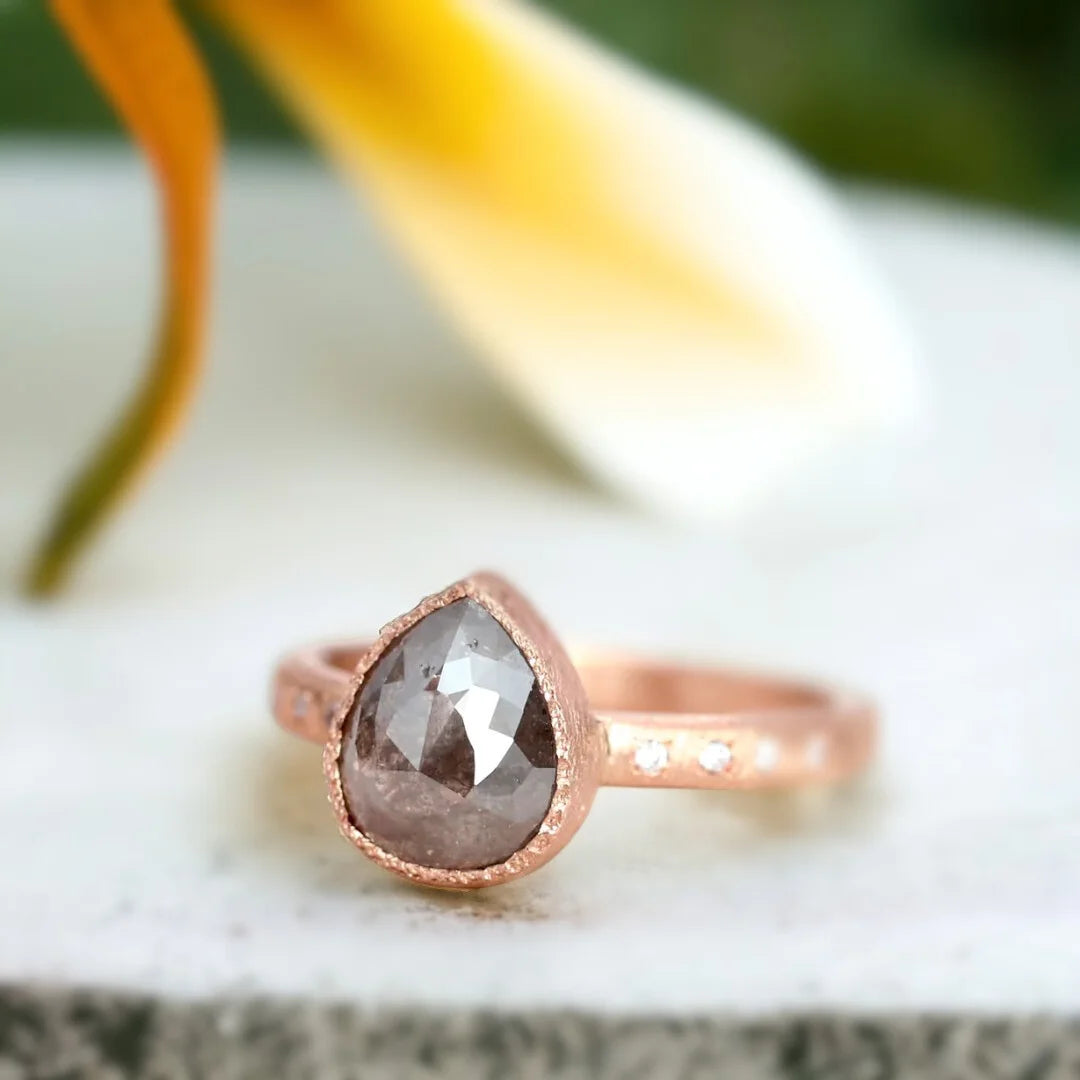 Rose Pear Salt and Pepper Diamond Ring with 2.70 CT Stone featuring a rose pear-cut salt-and-pepper diamond center stone, round side diamonds, straight shank band, and handcrafted artisan ring design with a textured organic finish.