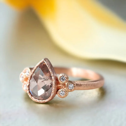 Rose Pear Salt and Pepper Diamond Ring Frosted Flame Diamond Ring featuring a rose pear-cut salt-and-pepper center diamond with a soft curved pear silhouette, round side diamonds, straight band design, and elegant handcrafted detailing with organic textured finish and ethical craftsmanship.