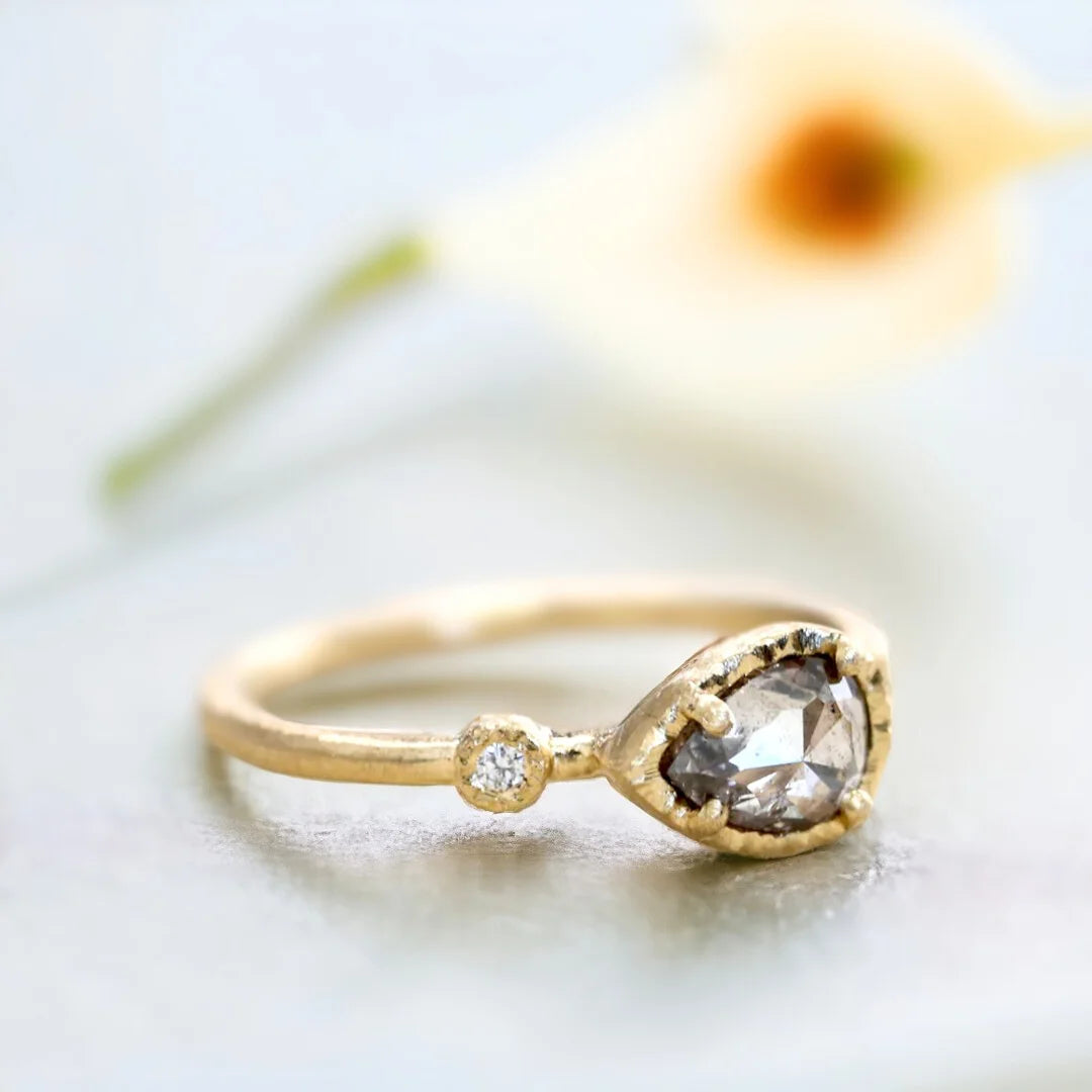 Rose Pear Salt and Pepper Diamond Ring With Side Diamonds featuring a 1.10 CT rose pear cut salt and pepper diamond, round side diamonds, delicate side stone design, straight shank band, and handcrafted engagement ring style.