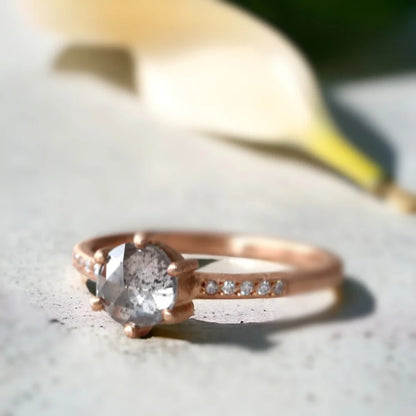 Round Rose Cut Salt And Pepper Diamond Ring With White Accent Diamonds featuring a round rose cut salt and pepper diamond center stone with white round accent diamonds, a straight shank ring design, and a handcrafted textured band with organic detailing.