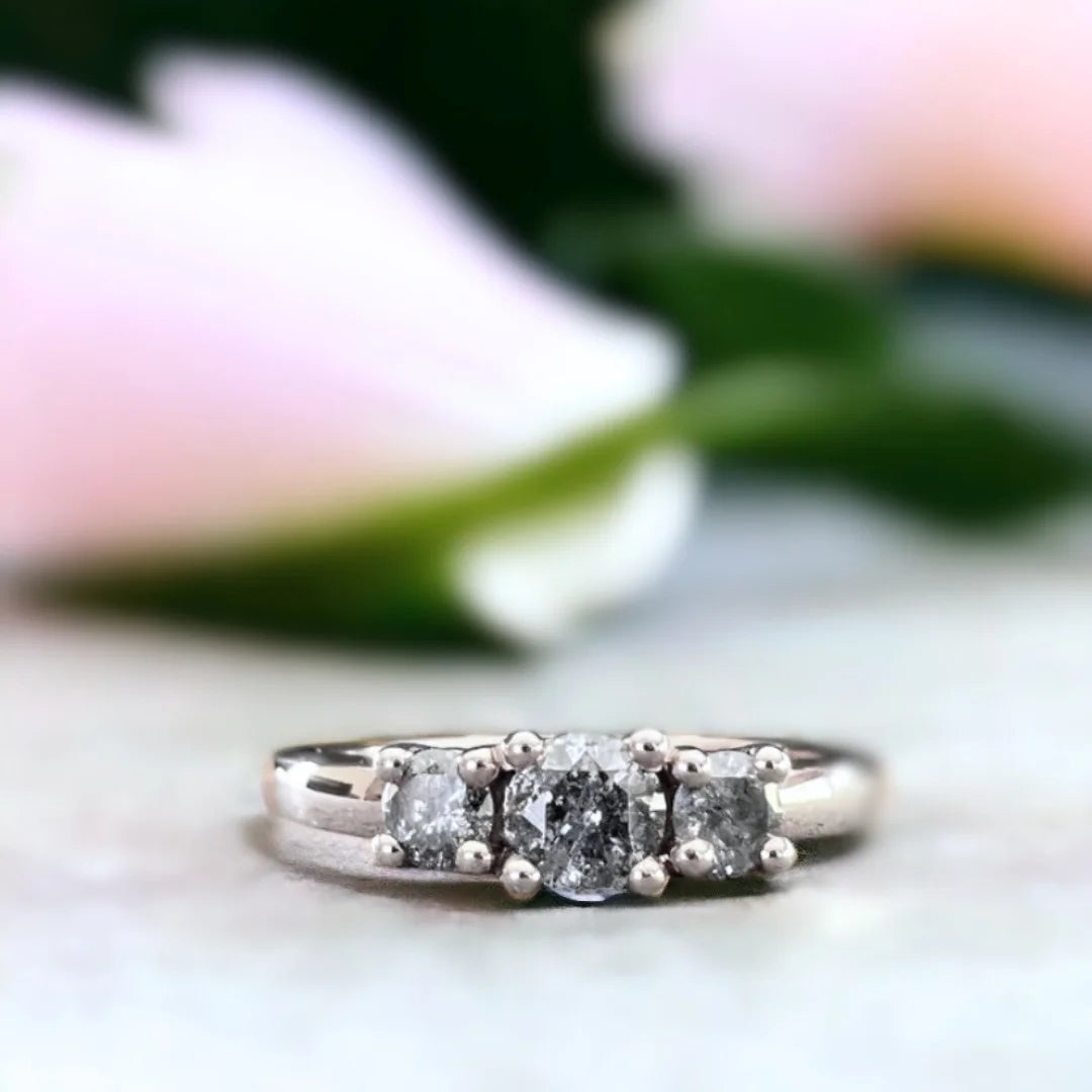 Round Salt and Pepper Diamond Ring Beacon of Love Design featuring a round salt and pepper diamond center stone with subtle round accent side stones set on a delicate straight band in a minimalist handcrafted engagement ring style.