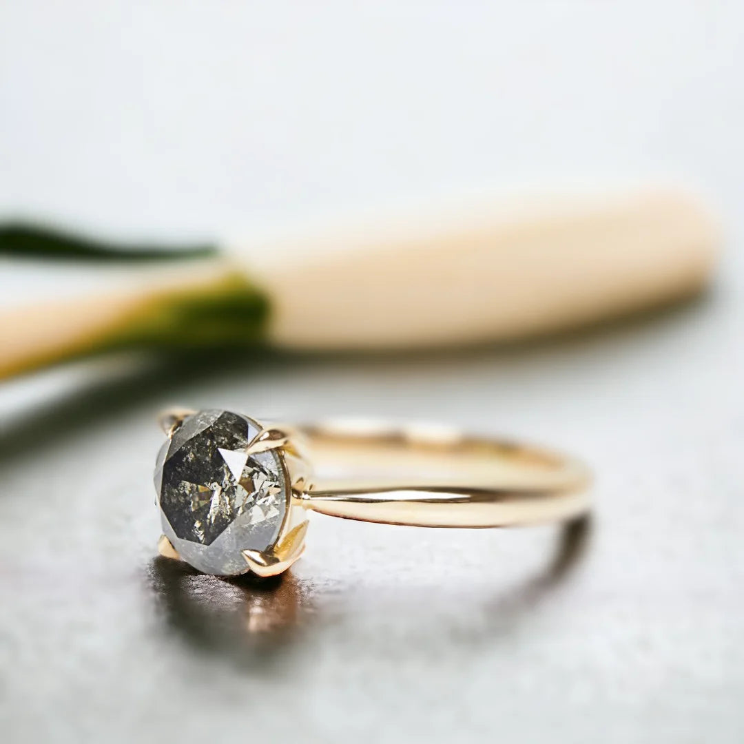 Round Salt and Pepper Diamond Ring with 1.60 CT Round Cut Stone featuring a natural round-cut salt-and-pepper diamond in a solitaire setting with a straight shank band and a minimalist, elegant ring design.