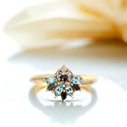 Salt and Pepper Cluster Diamond Ring Marquise Aquamarine Engagement featuring a cluster design with salt and pepper diamonds, black diamonds, and a light blue sapphire in mixed marquise, princess, and round cuts set in a slim, minimalist band
