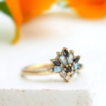 Salt and Pepper Cluster Diamond Ring Marquise Aquamarine Engagement featuring a cluster design with salt and pepper diamonds, black diamonds, and a light blue sapphire in mixed marquise, princess, and round cuts set in a slim, minimalist band